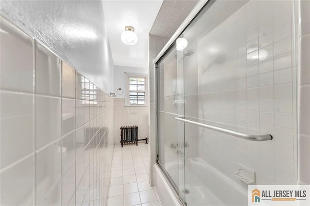 224 2nd St, South Amboy, NJ 08879 - bathroom featuring tile walls, shower / bath combination with glass door, tile patterned flooring, and radiator heating unit