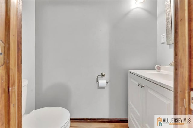 224 2nd St, South Amboy, NJ 08879 - half bathroom featuring toilet, vanity, and wood finished floors