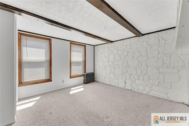 224 2nd St, South Amboy, NJ 08879 - carpeted spare room featuring radiator heating unit and beam ceiling
