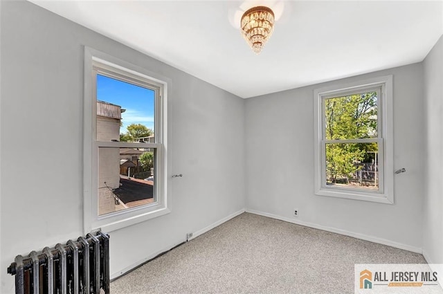 224 2nd St, South Amboy, NJ 08879 - spare room with radiator, baseboards, and carpet flooring