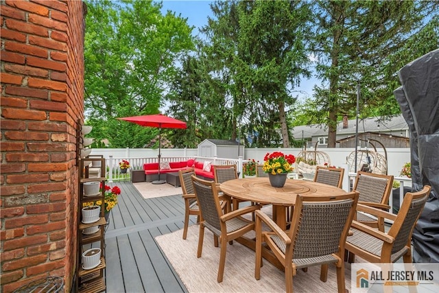 43 S Brook Dr, Milltown, NJ 08850 - wooden deck featuring a storage unit, outdoor dining space, a fenced backyard, and outdoor lounge area