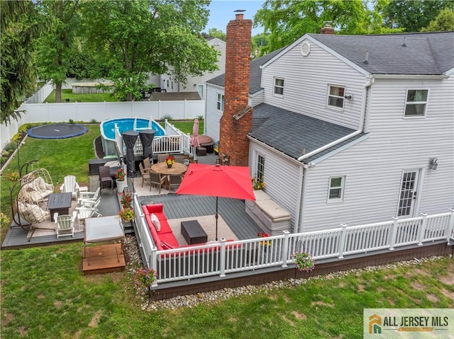 43 S Brook Dr, Milltown, NJ 08850 - back of property with outdoor lounge area, a wooden deck, and roof with shingles