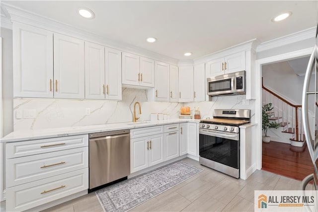 43 S Brook Dr, Milltown, NJ 08850 - kitchen with stainless steel appliances, white cabinets, tasteful backsplash, crown molding, and recessed lighting