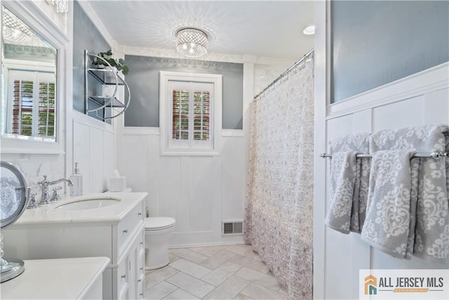 43 S Brook Dr, Milltown, NJ 08850 - full bath featuring wainscoting, healthy amount of natural light, a decorative wall, vanity, and a shower with shower curtain