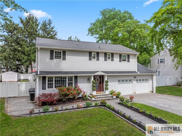43 S Brook Dr, Milltown, NJ 08850 - view of front facade featuring decorative driveway, an attached garage, and a gate