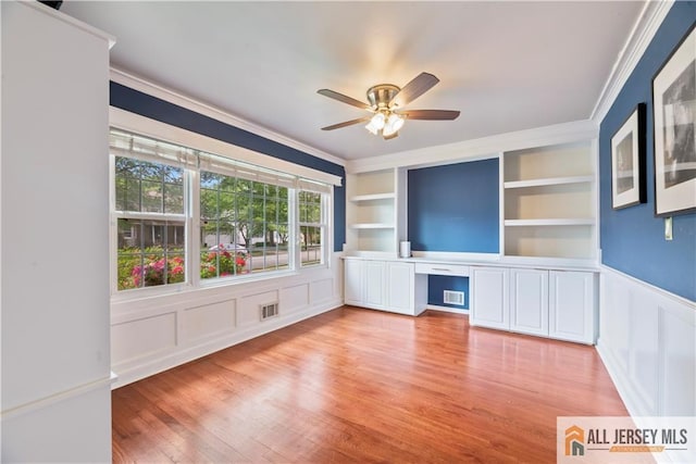 43 S Brook Dr, Milltown, NJ 08850 - empty room with ornamental molding, ceiling fan, light wood-type flooring, a decorative wall, and a wainscoted wall