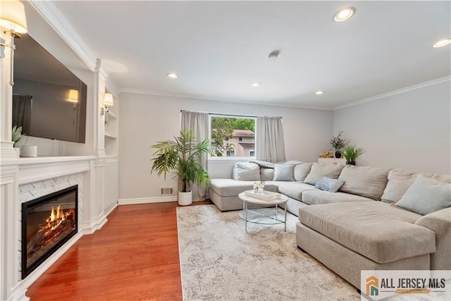 43 S Brook Dr, Milltown, NJ 08850 - living area featuring wood finished floors, crown molding, recessed lighting, a premium fireplace, and built in shelves