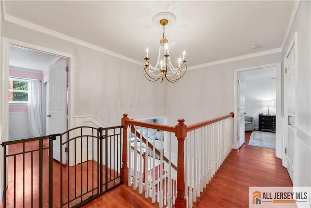 43 S Brook Dr, Milltown, NJ 08850 - hallway with an upstairs landing, a chandelier, wood finished floors, and crown molding
