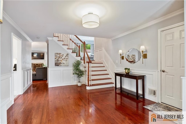 43 S Brook Dr, Milltown, NJ 08850 - entryway with a decorative wall, stairway, ornamental molding, a fireplace, and wood finished floors
