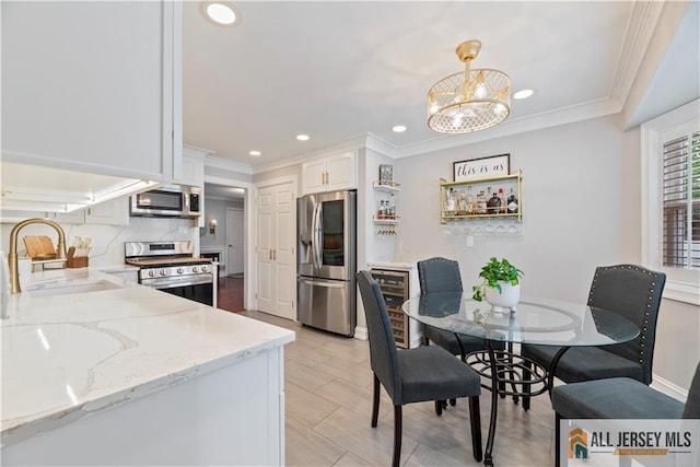 43 S Brook Dr, Milltown, NJ 08850 - kitchen featuring stainless steel appliances, recessed lighting, light stone countertops, crown molding, and white cabinets