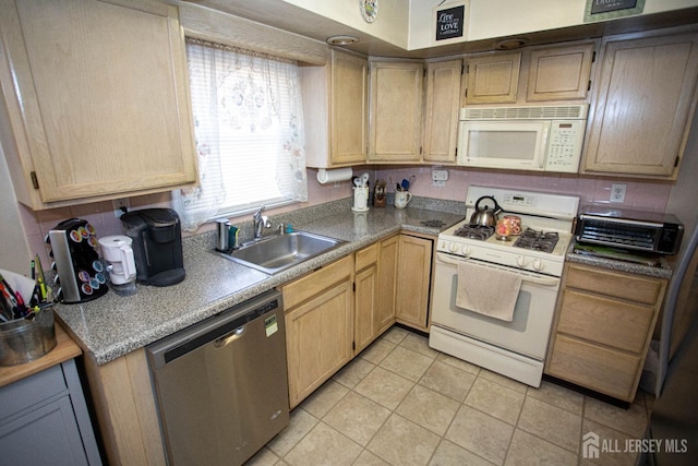 kitchen featuring light tile patterned flooring, white appliances, sink, and light brown cabinets