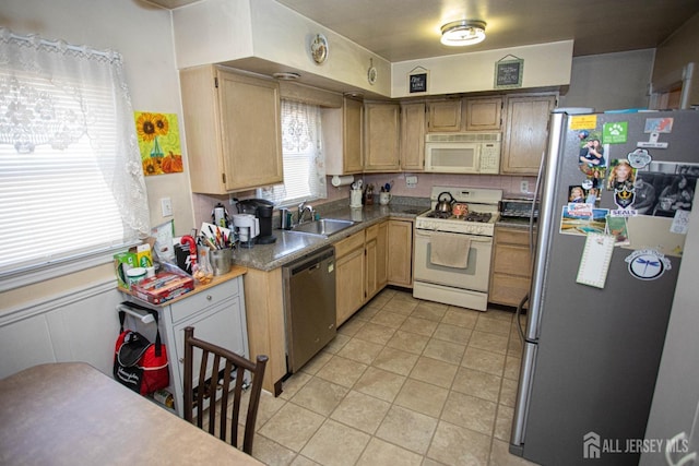 kitchen with sink, light tile patterned floors, and stainless steel appliances