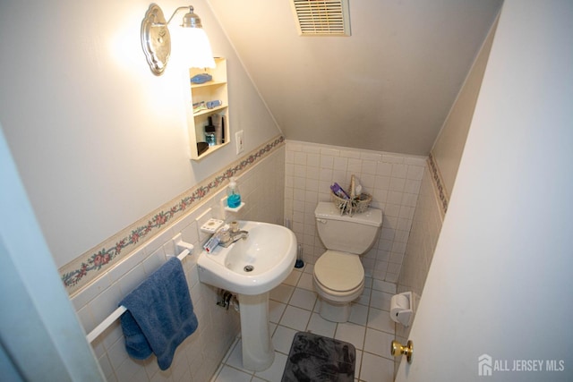 bathroom featuring sink, tile walls, tile patterned floors, and toilet