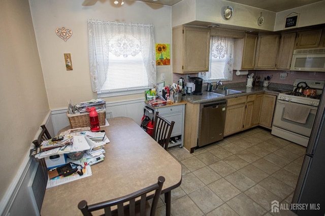 kitchen featuring ceiling fan, white appliances, sink, and light tile patterned floors