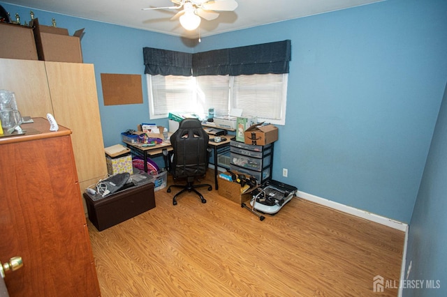 office with ceiling fan and light hardwood / wood-style floors