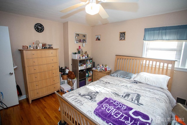 bedroom with hardwood / wood-style floors and ceiling fan