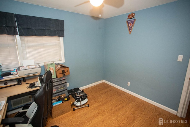 office with hardwood / wood-style flooring and ceiling fan