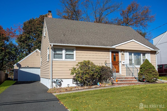 view of front facade with a garage, an outbuilding, and a front lawn