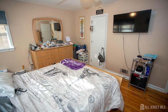 bedroom with hardwood / wood-style flooring and ceiling fan