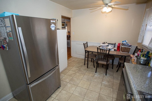 tiled dining space with ceiling fan