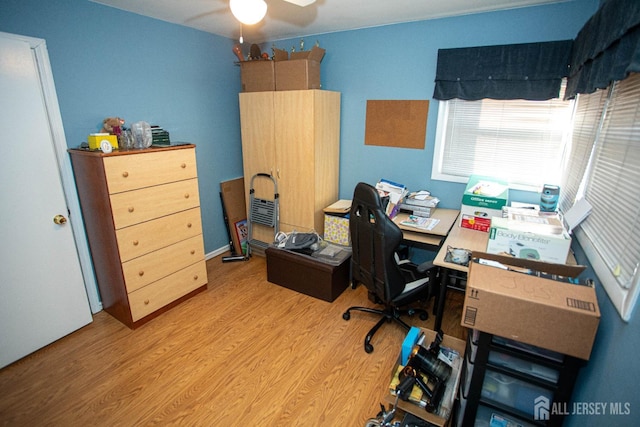 home office featuring light hardwood / wood-style floors and ceiling fan