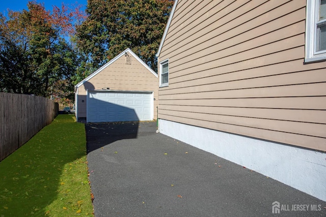 view of side of property featuring a garage and an outdoor structure