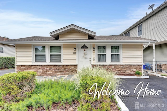 220 Birchwood Dr, Old Bridge, NJ 07735 - view of front of property with stone siding and roof with shingles