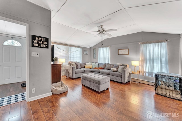 220 Birchwood Dr, Old Bridge, NJ 07735 - living area featuring a baseboard heating unit, vaulted ceiling, plenty of natural light, ceiling fan, and wood finished floors