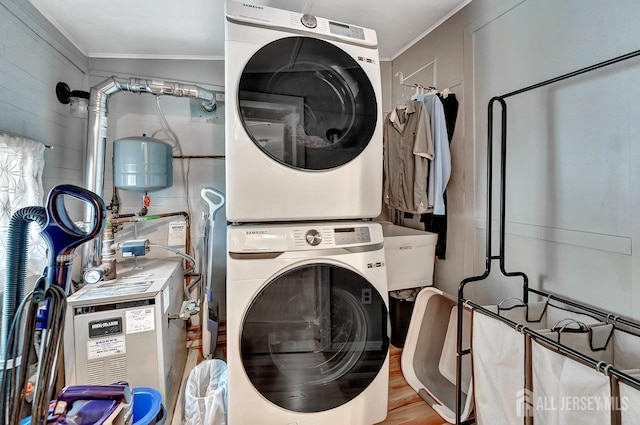 220 Birchwood Dr, Old Bridge, NJ 07735 - washroom featuring stacked washer and clothes dryer, ornamental molding, and wood finished floors