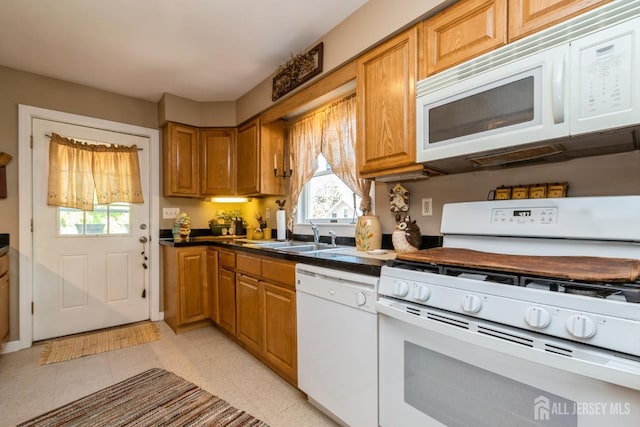 245 S Madison Ave S, Dunellen, NJ 08812 - kitchen with white appliances, healthy amount of natural light, dark countertops, and brown cabinetry