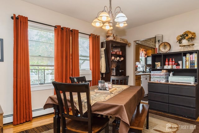 245 S Madison Ave S, Dunellen, NJ 08812 - dining area featuring a chandelier, wood finished floors, and a baseboard heating unit