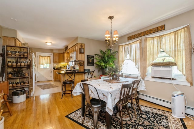 245 S Madison Ave S, Dunellen, NJ 08812 - dining area with a chandelier, light wood-type flooring, a baseboard radiator, and cooling unit