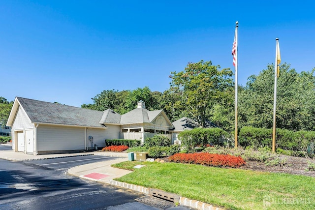 2 Honey Locust Ln, Howell, NJ 07731 - view of front of home with a chimney, a front lawn, and a garage