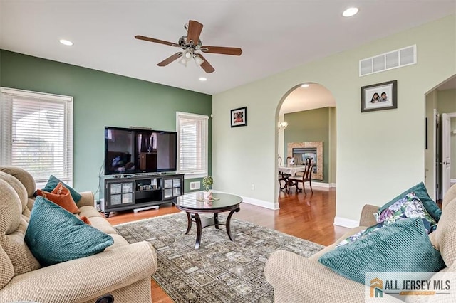 living room featuring hardwood / wood-style flooring and ceiling fan