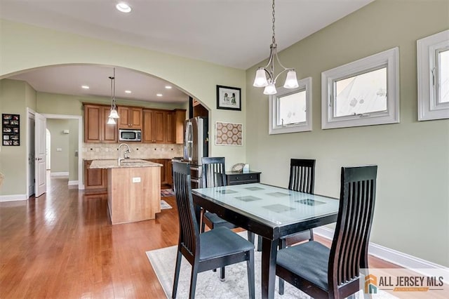 dining space featuring sink and hardwood / wood-style floors