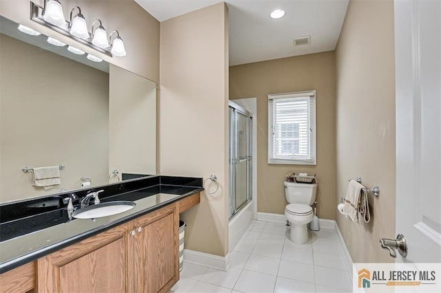 full bathroom with vanity, tile patterned flooring, shower / bath combination with glass door, and toilet