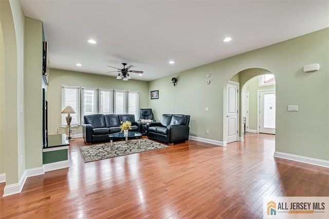 living room with ceiling fan and light wood-type flooring