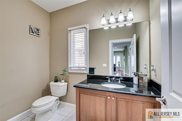 bathroom with vanity, toilet, and tile patterned flooring