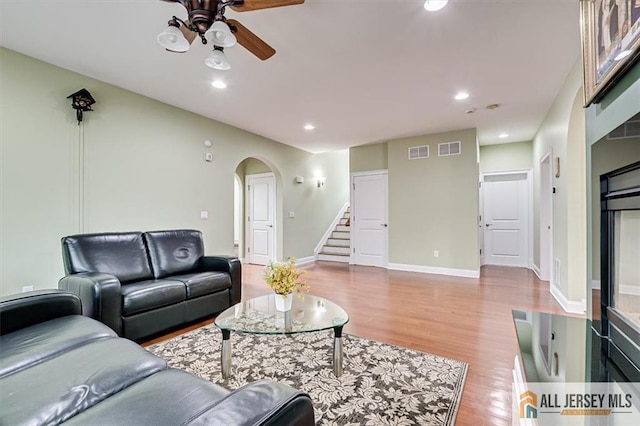 living room featuring ceiling fan and light wood-type flooring