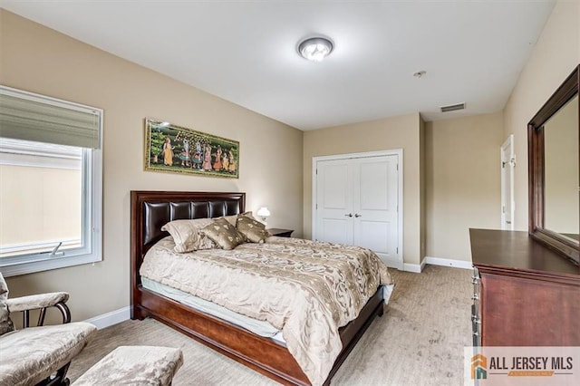 carpeted bedroom with a closet