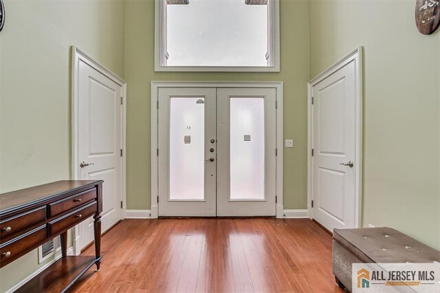 entryway with light wood-type flooring and french doors