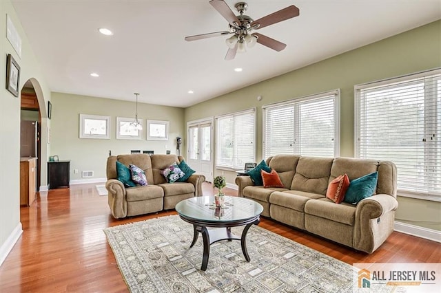 living room featuring ceiling fan and light hardwood / wood-style floors