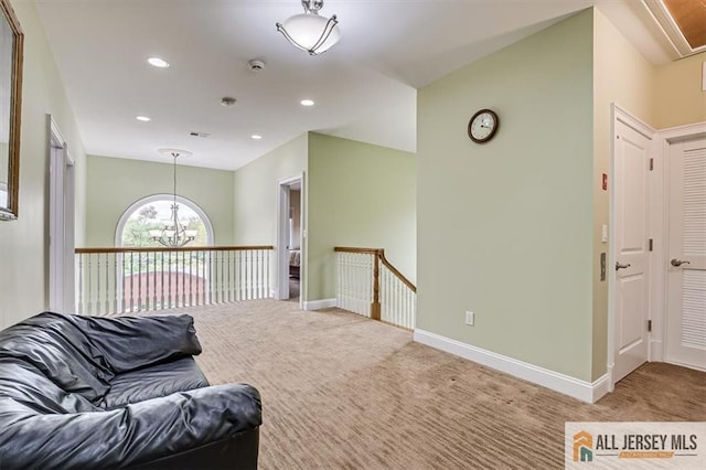 living area with carpet floors and a notable chandelier