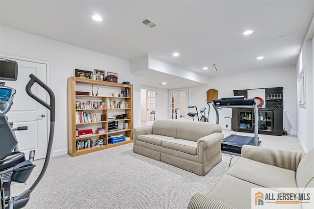 living room featuring light carpet and french doors