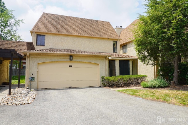 14 Carriage Pl, Edison, NJ 08820 - view of front of property with stucco siding, asphalt driveway, and roof with shingles