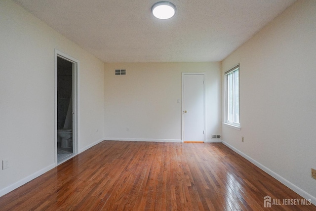 14 Carriage Pl, Edison, NJ 08820 - unfurnished room featuring wood finished floors and a textured ceiling