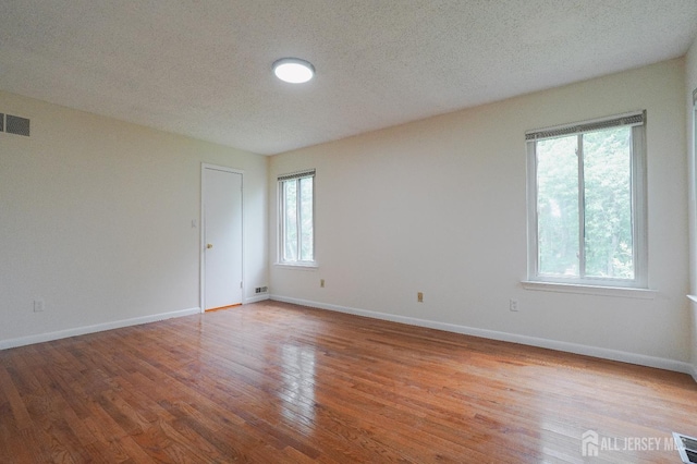14 Carriage Pl, Edison, NJ 08820 - unfurnished room featuring wood finished floors and a textured ceiling
