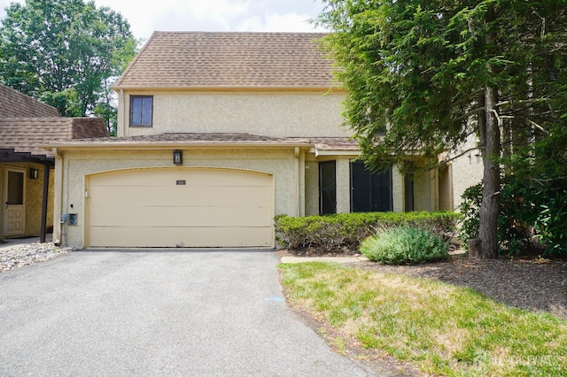 14 Carriage Pl, Edison, NJ 08820 - view of front of home with stucco siding, driveway, and a shingled roof