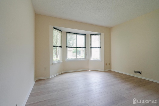 14 Carriage Pl, Edison, NJ 08820 - empty room featuring light wood finished floors and a textured ceiling