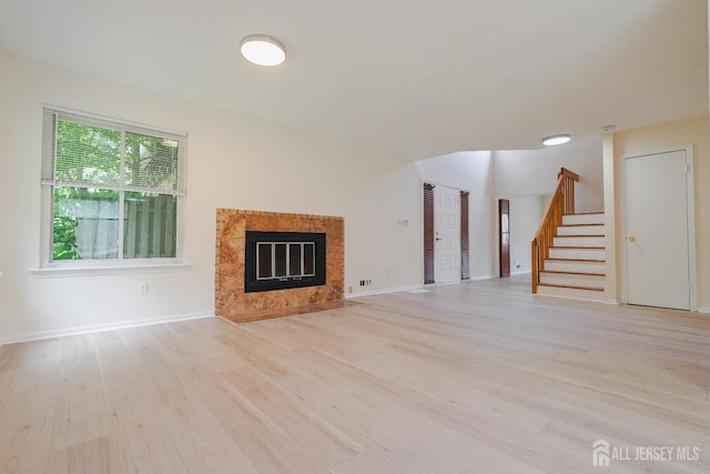 14 Carriage Pl, Edison, NJ 08820 - unfurnished living room with stairs, light wood-type flooring, and a fireplace
